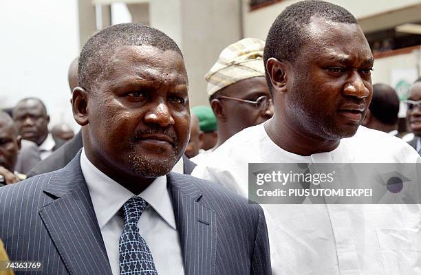 Nigerian businessman Aliko Dangote and Femi Otedola arrive for the opening of the second Lagos domestic airport MM2, 07 April 2007. AFP PHOTO / PIUS...