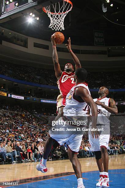 LeBron James of the Cleveland Cavaliers goes to the hoop past Bobby Jones and Joe Smith of the Philadelphia 76ers at Wachovia Center on April 17,...