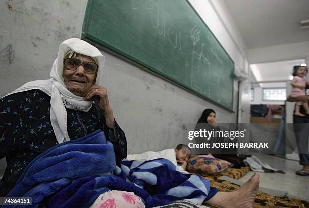 Amina Omar who fled the Palestinian besieged refugee camp of Nahr al-Bared, sits at a school's classroom at the adjacent refugee camp of Beddawi, in...