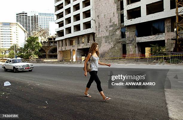 Woman walks 31 May 2007 over what used to be a huge crater at the site where a massive car bomb killed Lebanese prime minister Rafiq Hariri in Beirut...