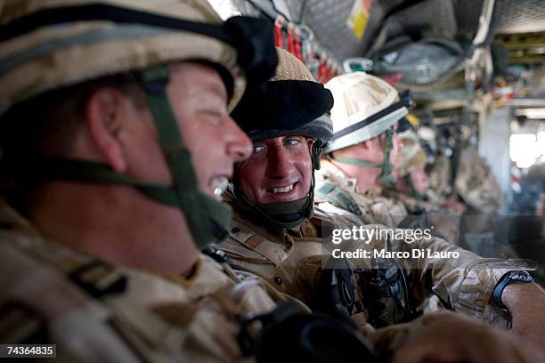 British Soldiers from different regiments are seen on a Chinook helicopter as they are deployed from Camp Bastion to Fob Rob in Sangin Valley to...