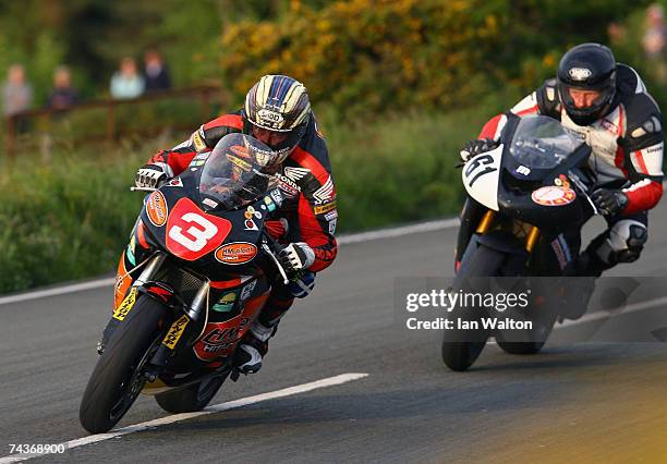 John McGuinness of England and Stephen Herper rides during practice for the 2007 Isle of Man Tourist Trophy races on May 31, 2007 in Ramsey, Isle of...