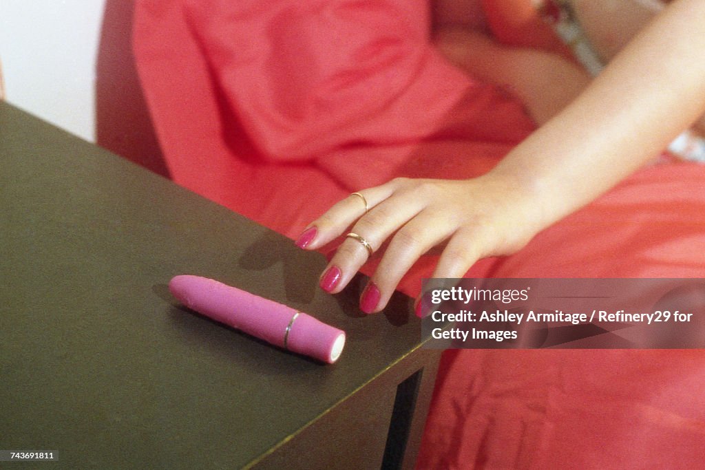 Young Woman Reaching For Vibrator