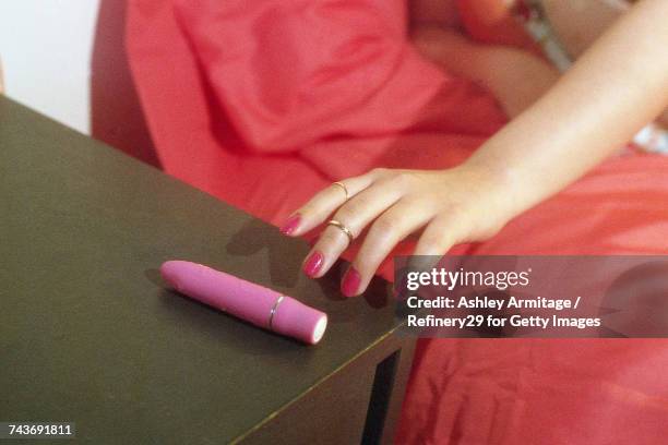 young woman reaching for vibrator - 67percentcollection stock pictures, royalty-free photos & images