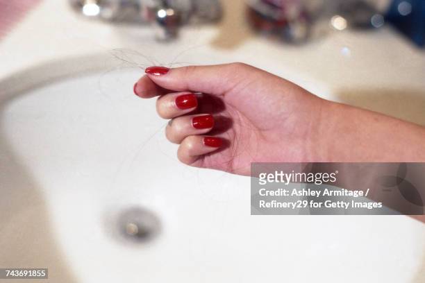 young woman holding hair - 67percentcollection stock pictures, royalty-free photos & images