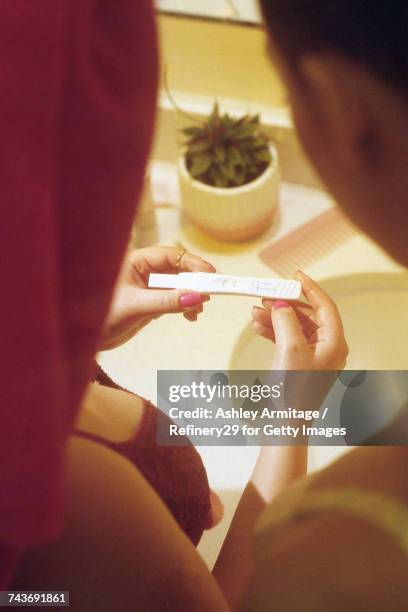 young women looking at pregnancy test  - 67percentcollection bildbanksfoton och bilder