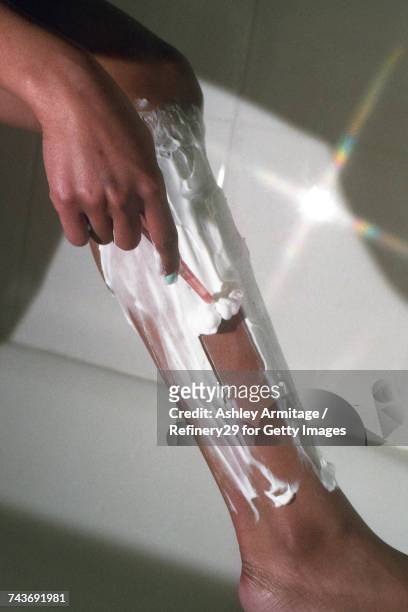young woman shaving her legs - 67percentcollection bildbanksfoton och bilder