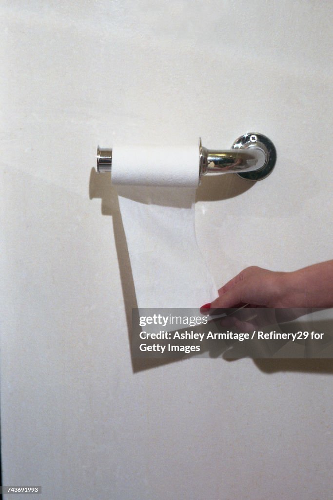 Young Woman Grabbing Toilet Paper