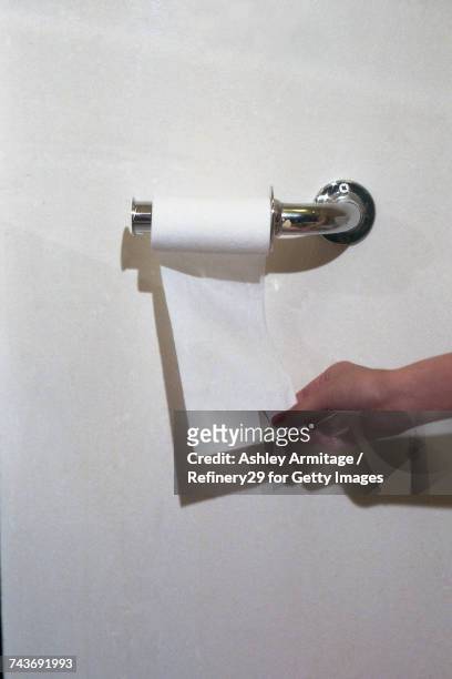 young woman grabbing toilet paper - 67percentcollection stock pictures, royalty-free photos & images