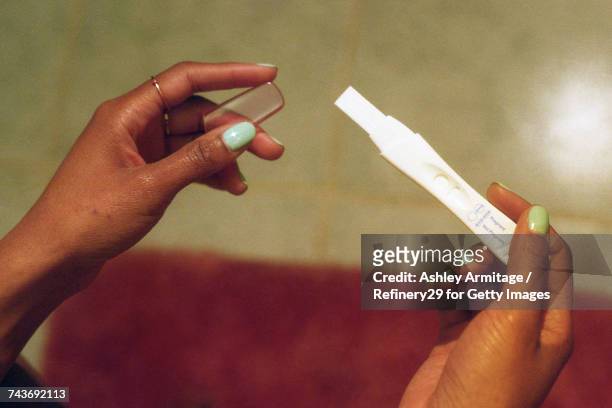 young woman looking at pregnancy test  - 67percentcollection bildbanksfoton och bilder