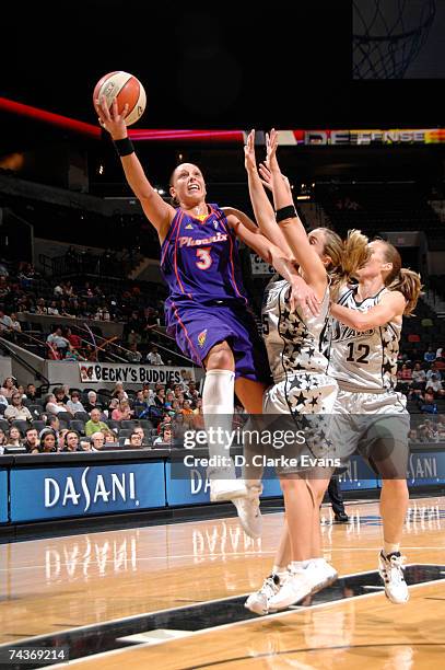 Diana Taurasi of the Phoenix Mercury shoots against Becky Hammon of the San Antonio Silver Stars during the game at the AT&T Center on May 31, 2007...