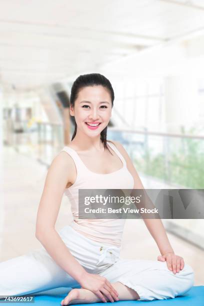 studio shot young woman doing yoga - yoga studio shot stock pictures, royalty-free photos & images