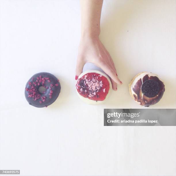 Womans hand reaching for doughnuts