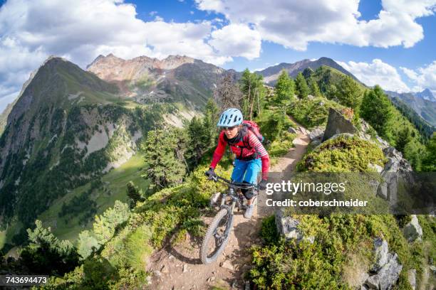 woman mountain biking near mont blanc, aosta valley, switzerland - extreme stock pictures, royalty-free photos & images