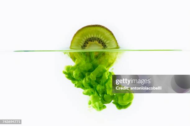 kiwi fruit dissolving in water - raw acrylic stock pictures, royalty-free photos & images