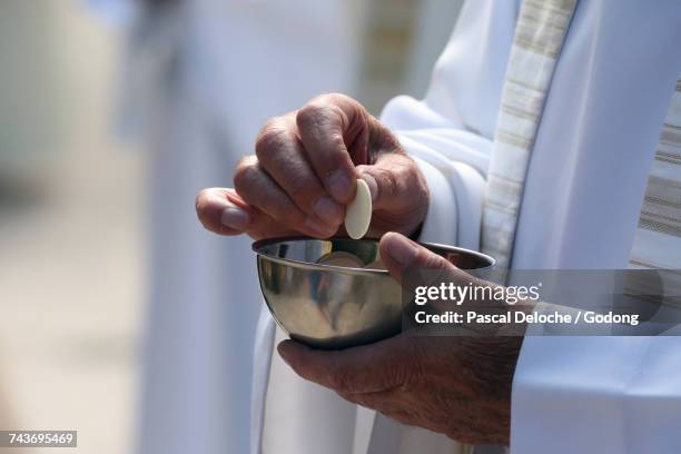 sanctuary of la benite fontaine. catholic mass.  holy communion.  france. - catholicism stock-fotos und bilder