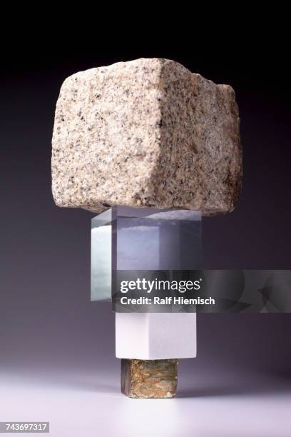 stack of block shaped stones and glass boxes against gray background - natural stone block stock pictures, royalty-free photos & images