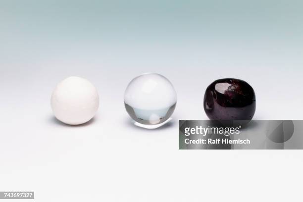 various marbles arranged on white background - black cherries imagens e fotografias de stock