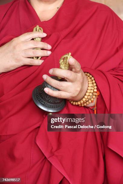 monk using bell (ghanta) and vajra. france. - símbolo religioso fotografías e imágenes de stock