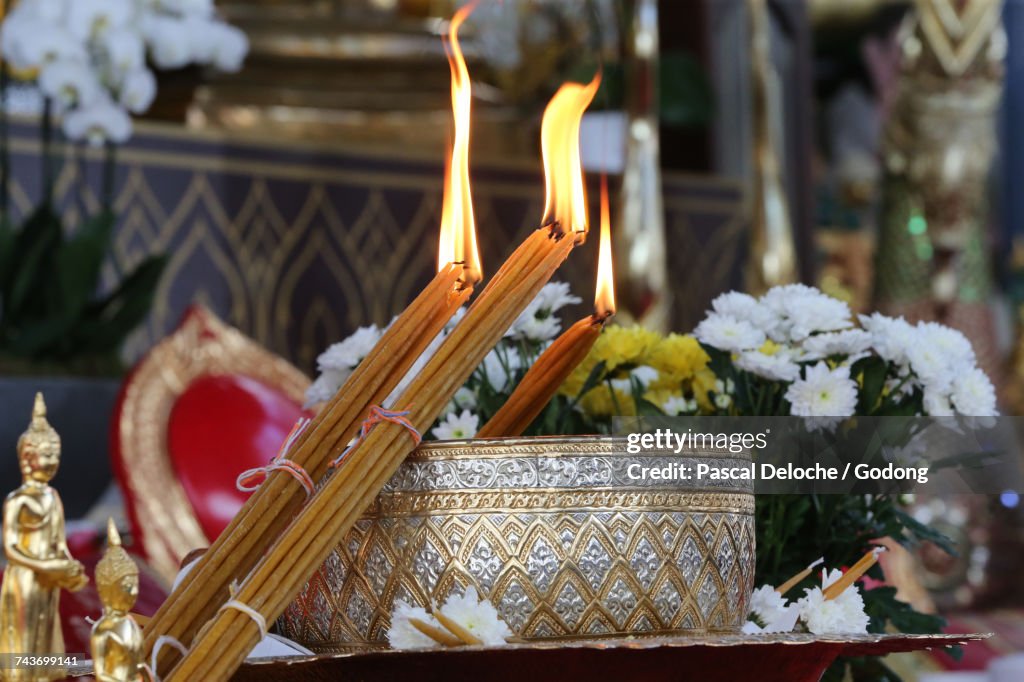 Wat Velouvanaram. Buddha statues and buddhist holy water blessing brass bowl. France.