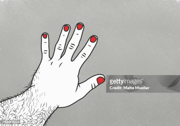 Cropped image of man with red nail polish on finger against gray background