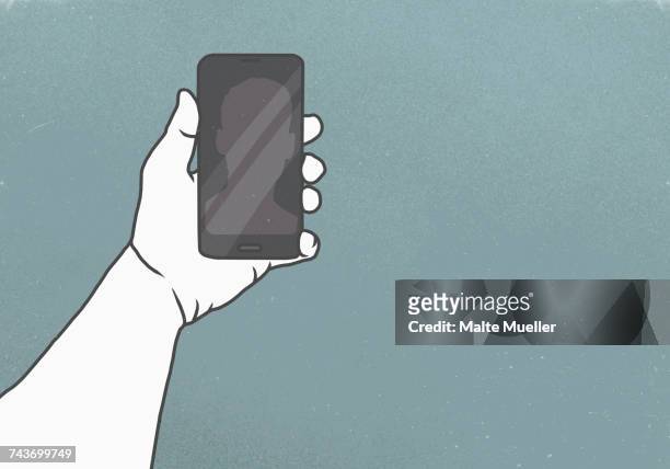 cropped image of hand holding smart phone against gray background - bearbeitungstechnik stock-grafiken, -clipart, -cartoons und -symbole