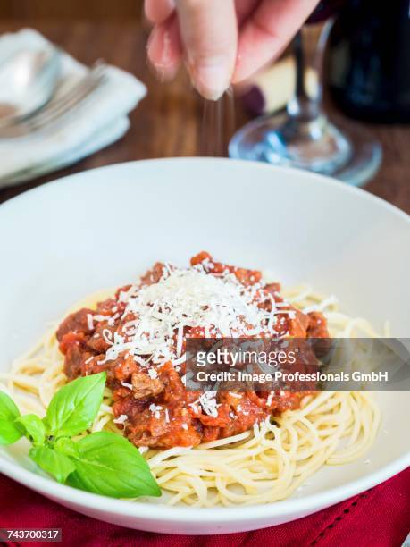 spaghetti with vegetarian bolognese and parmesan cheese - wine glass finger food stock-fotos und bilder