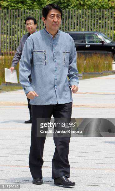 Japanese Prime Minister Shinzo Abe wearing an Okinawan ''Kariyushi'' casual shirt arrives at the Prime Minister's official residence June 1, 2007 in...