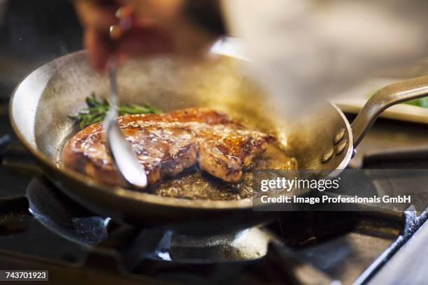 fried beef steak in a pan - sauteren stockfoto's en -beelden