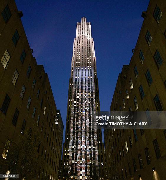 New York, UNITED STATES: The facade of 30 Rockefeller Plaza is lit up with 250 projected photographs projected 50-stories high of smiling New Yorkers...