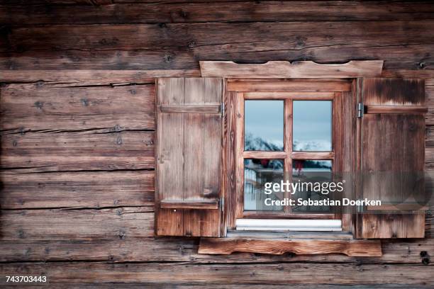 reflection on glass window of log cabin, kufstein, tyrol, austria - hut stock pictures, royalty-free photos & images