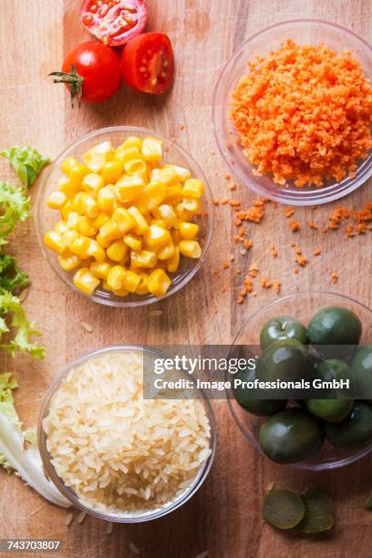 ingredients for a rice salad with sweetcorn, green olives, tomatoes and carrots - curly endive stock pictures, royalty-free photos & images