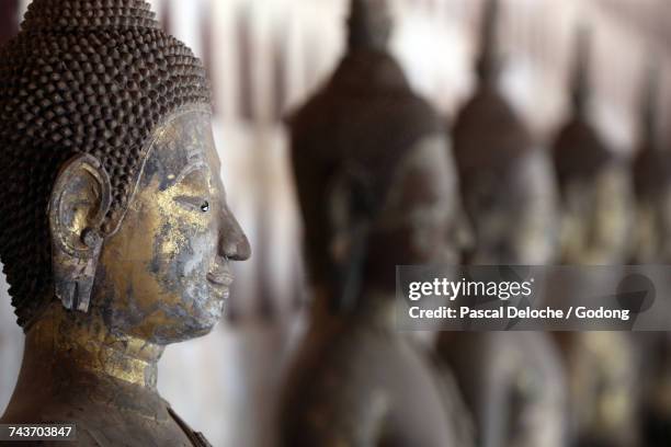 wat sisaket (si saket) buddhist temple.  old buddha statues in the cloister or gallery surrounding the sim.  laos. - wat si saket imagens e fotografias de stock