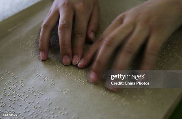 Blind child reads a braille book at the Wuhan School for the Blind on May 31, 2007 in Wuhan of Hubei Province, China. The Wuhan School for the Blind...