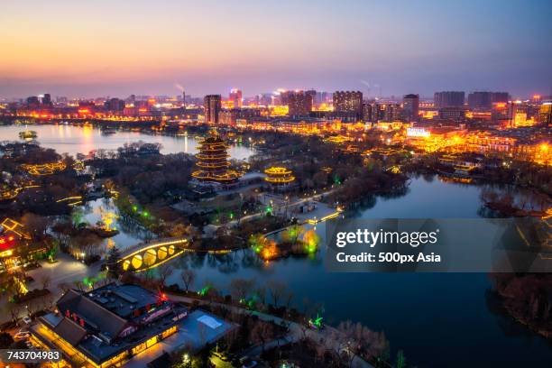 illuminated cityscape at night, jinan, shandong, china - jinan city stock-fotos und bilder