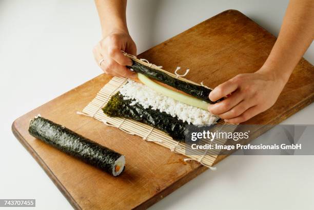 rolling the sushis - sushis stock-fotos und bilder