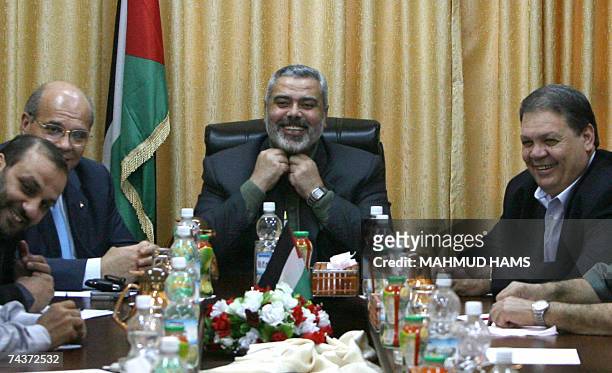 Palestinian prime minister Ismail Haniya smiles during a meeting with security chiefs at his office in Gaza City, 01 June 2007. Palestinian factions...