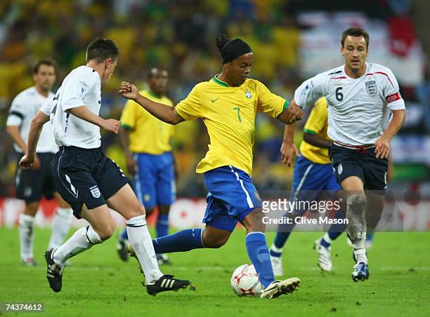 Ronaldinho of Brazil is watched by Nicky Shorey and John Terry of England during the International Friendly match between England and Brazil at...