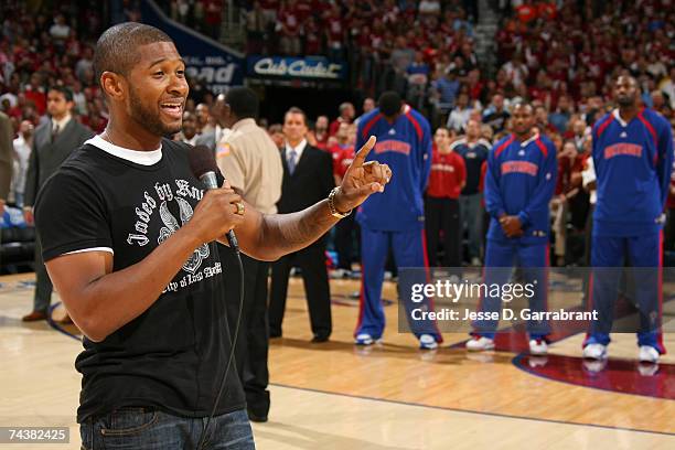 Rapper Usher sings the National Anthem prior to Game Six of the Eastern Conference Finals between the Cleveland Cavaliers and Detroit Pistons during...