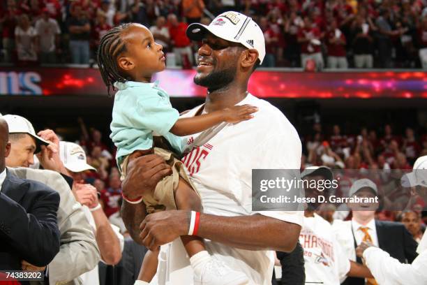 LeBron James of the Cleveland Cavaliers holds his son LeBron Jr. Following the Cavaliers victory in Game Six of the Eastern Conference Finals during...