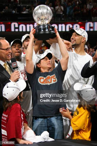 Majority owner Daniel Gilbert of the Cleveland Cavaliers holds the Eastern Conference Championship trophy above his head following Game Six of the...