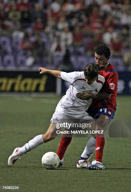 Costa Rica's Michael Barrantes fights for the ball with Chile's Jorge Valdivia during their friendly football match at the Ricardo Saprissa Stadium,...