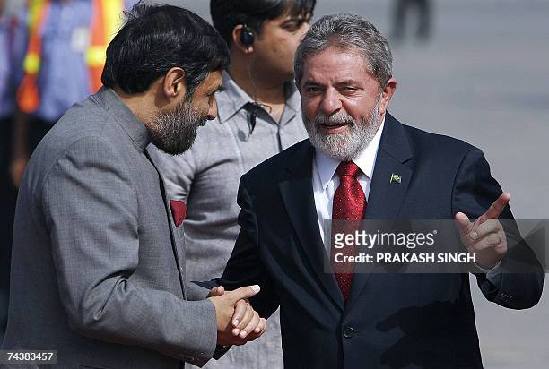 Brazilian President Luiz Inacio Lula da Silva gestures while talking with Indian Minister of State for External Affairs Anand Sharma upon his arrival...