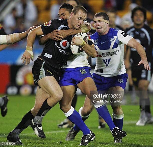 Simon Mannering of the Warriors gets tackled during the round 12 NRL match between the Warriors and the Bulldogs at Mt Smart Stadium June 3, 2007 in...