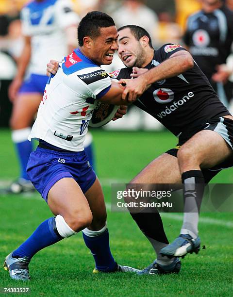 Ben Roberts of the Bulldogs fends off Wade McKinnon of the Warriors during the round 12 NRL match between the Warriors and the Bulldogs at Mt Smart...