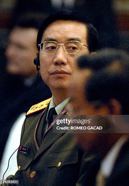 Chinese Lieutenant General Zhang Qinsheng, the head of military intelligence for the People's Liberation Army listens during the closing session of...