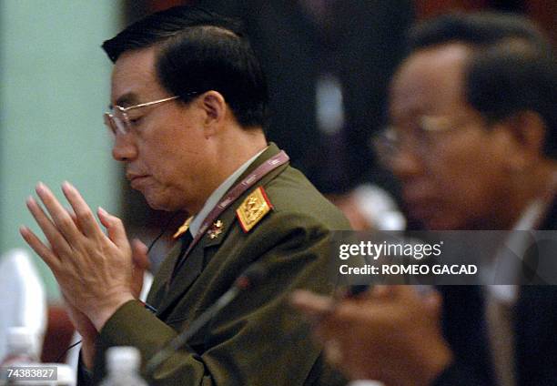 Chinese Lieutenant General Zhang Qinsheng , the head of military intelligence for the People's Liberation Army applauds during the closing session of...