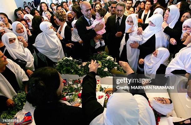 Lebanese man brings eight-month-old Rasha , the daughter of dead soldier Saqer Abu Ali, to give her a last view of her father during his funeral in...