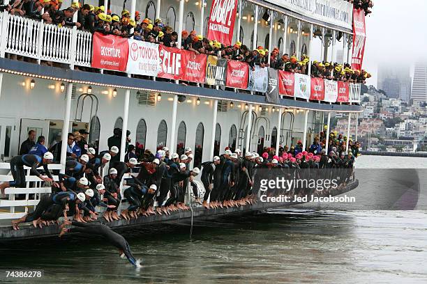 Athletes jump into the San Francisco Bay in front of Alcatraz island at the start of the Escape from Alcatraz Triathlon on June 3, 2007 in San...
