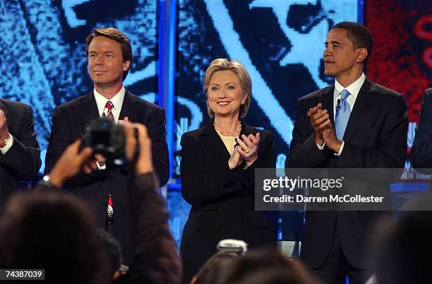 Democratic presidential candidates former Sen. John Edwards , Sen. Hillary Clinton and Sen. Barack Obama applaud as they take to the stage as they...